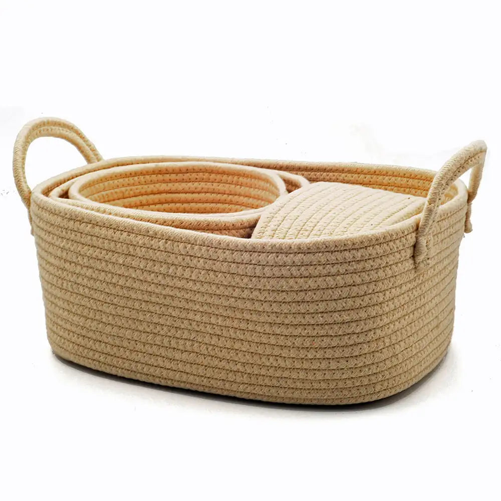 Beige woven basket with handles on a white background