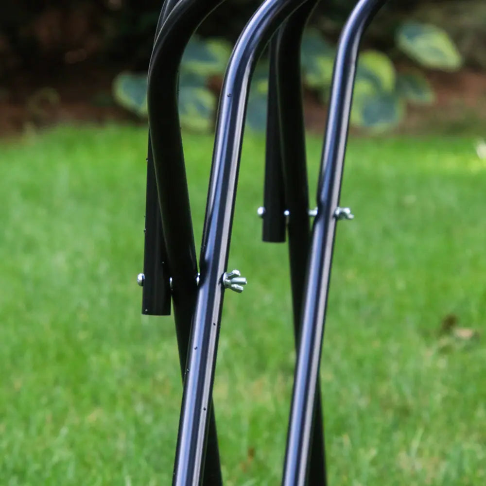 Close-up of a black metal bike rack on a grassy background