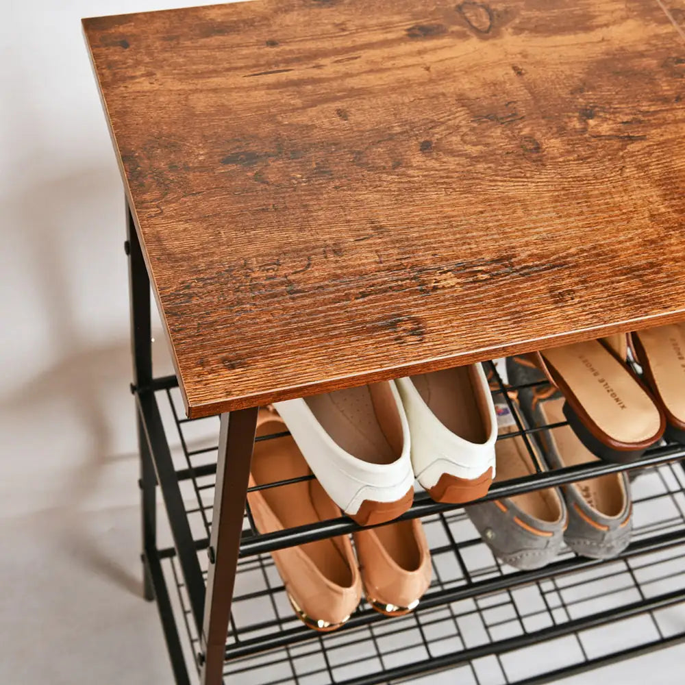 Wooden shoe rack with various shoes on a neutral background