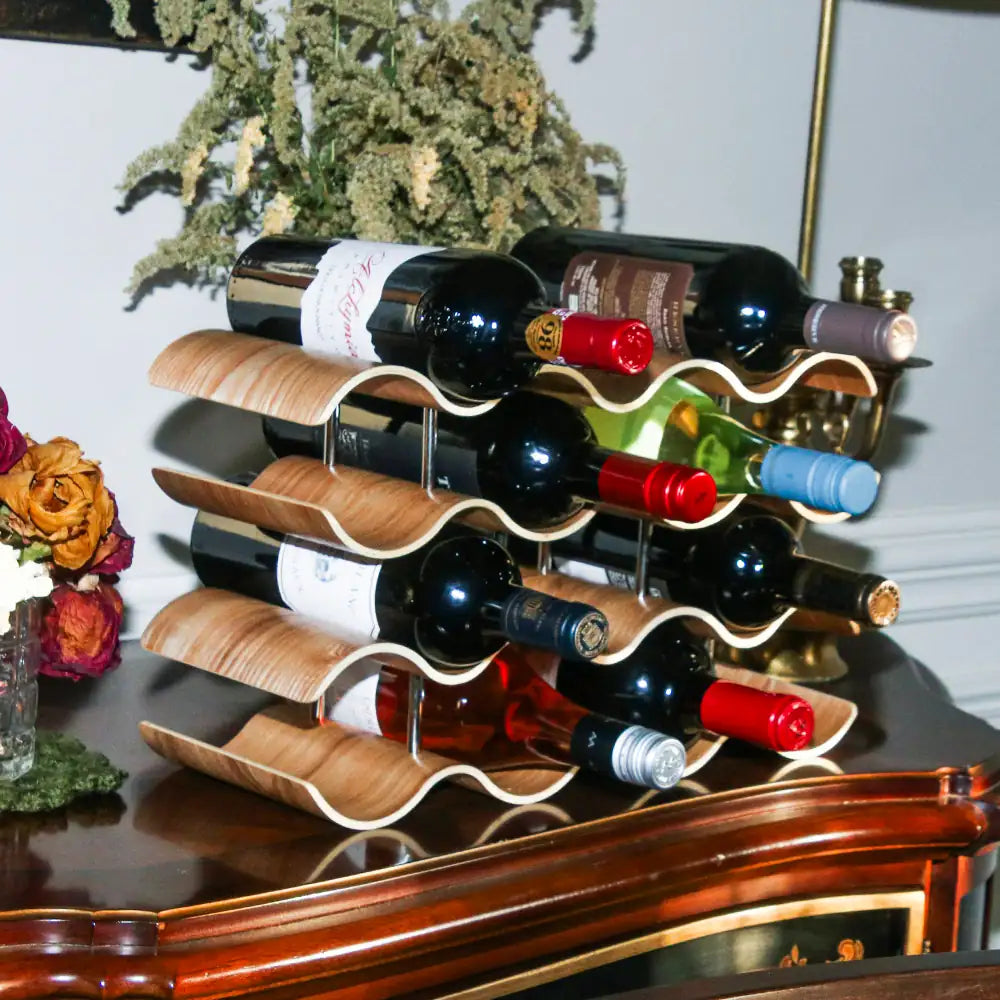 Wine rack with bottles on a reflective surface with decorative elements.
