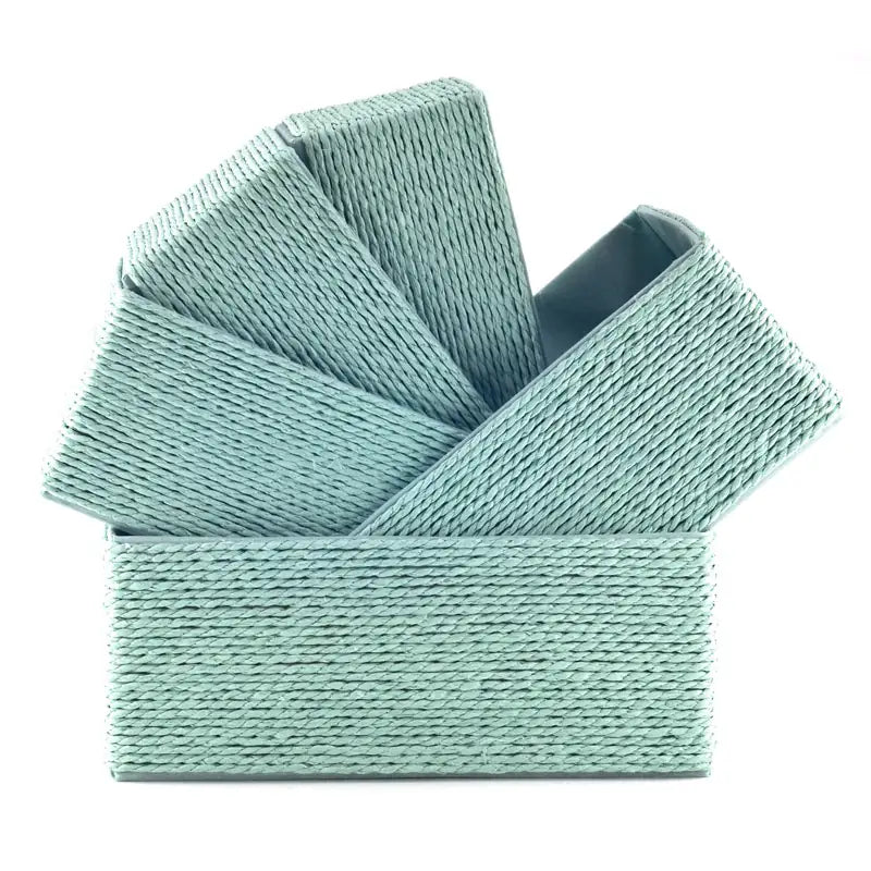 Five mint-colored woven paper rope baskets stacked diagonally inside each other