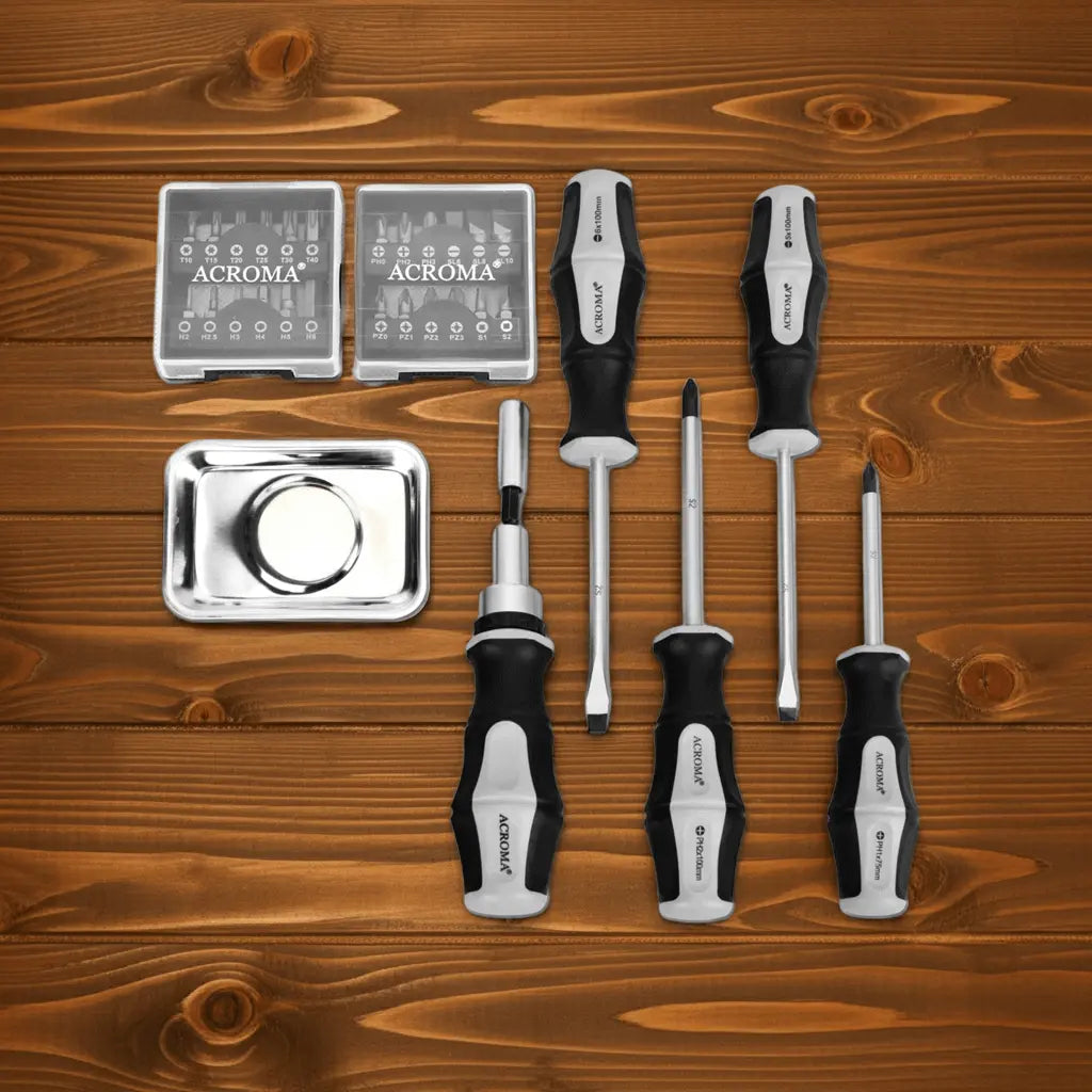 Set of screwdrivers and small tools on a wooden surface with 'ACROMA' branding.