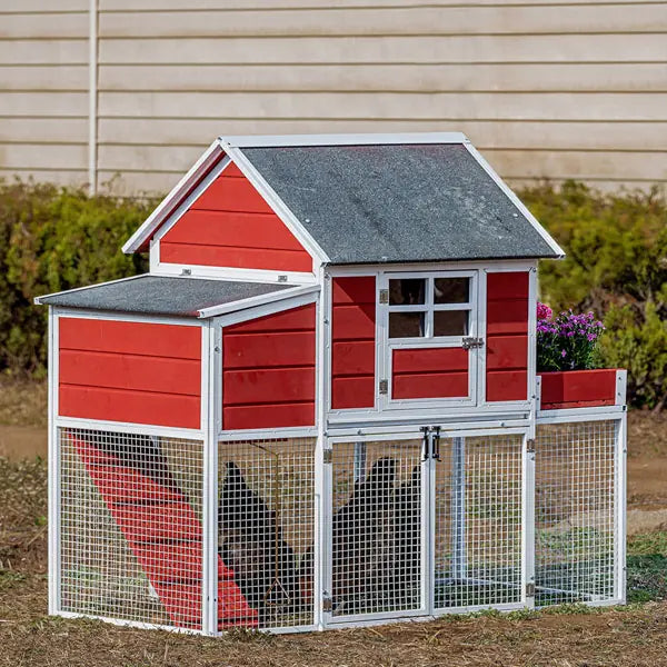 Red and white chicken coop with a gray roof in a backyard setting.