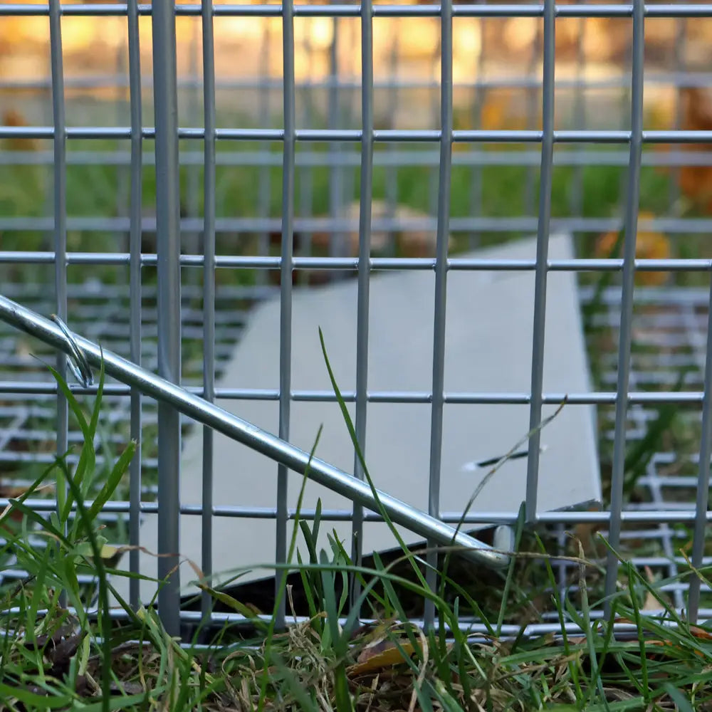 Metal shopping cart on grass with a blurred background
