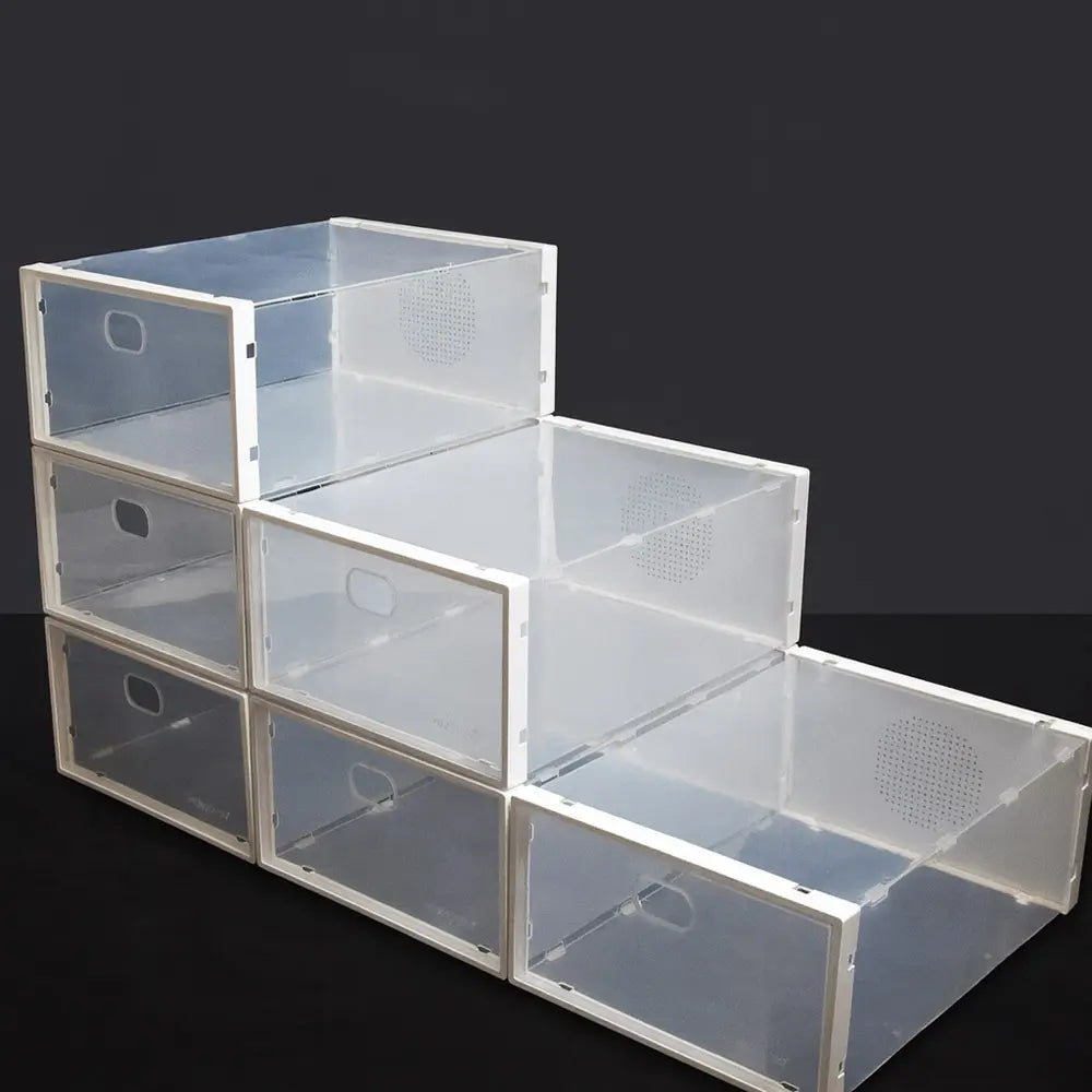 Stack of clear plastic storage boxes on a black background