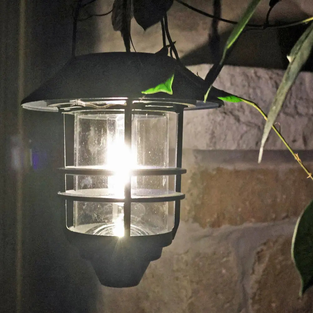 Solar-powered outdoor light fixture on a stone wall background