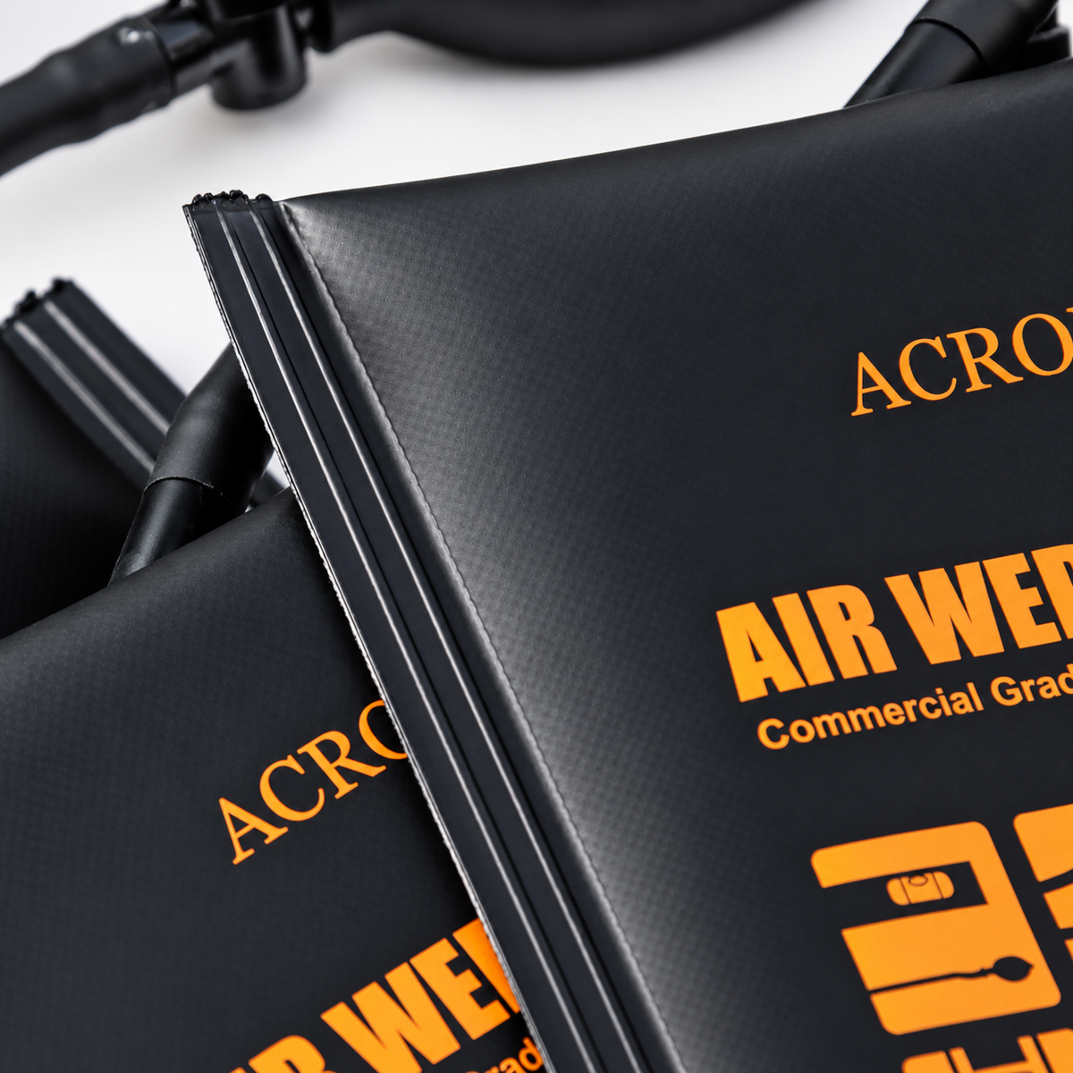 Close-up of Acroma black air wedge material with orange product markings and reinforced sealed edges.