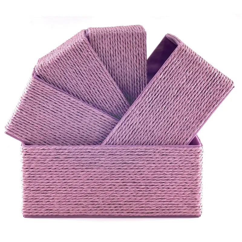 Five Lilac-colored woven paper rope baskets stacked diagonally inside each other